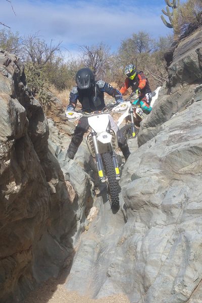 Riders navigating technical desert trails